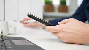 Businesswoman writes in document and uses smartphone. Businesswoman or entrepreneur in home office. Online business, marketing or learning concept. Tax return and business plan. tax declaration Stock Video