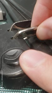 Vertical video. A Hand demonstrates how to use the combination lock, adjusting the code to unlock the zipper pulls on the suitcase.