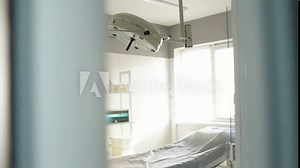 Modern surgical operating room through the slightly open clinic doors