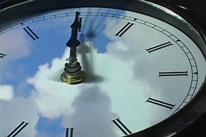 Fast moving clouds over clock in time-lapse (loop)
