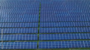 AERIAL: Numerous solar collectors for producing electricity in a sustainable way. Photovoltaic power station as a means of generating electricity. Solar-powered technology for a sustainable future.