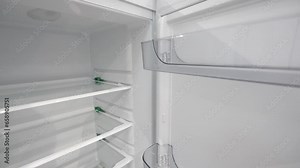 Open empty refrigerator. Refrigerator open empty fridge inside interior. Close up on empty refrigerator with door open. New clean refrigerator. Empty open fridge with shelves. Fridge interior.