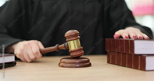 Judge knocking with wooden gavel near books in courtroom closeup 4k movie slow motion. Criminal and administrative liability for violation of laws concept