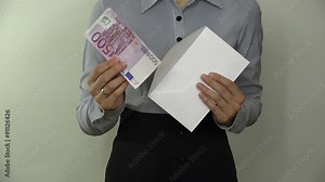 Woman hands take 500 five hundred euro cash money banknote from envelope on white background. Officer got bribe. Employee hand check envelope with salary. Closeup shot. 4K UHD video clip.
