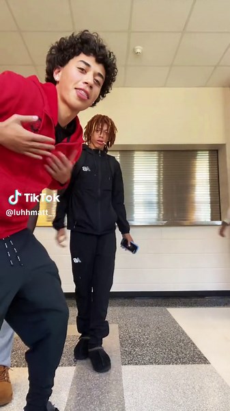 Boys Dancing to Tap Out Routine in School Hallway