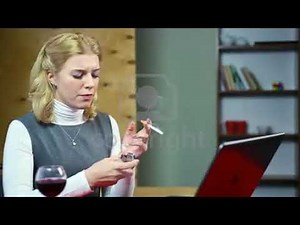 Lady working on computer and smoking cigarette at workplace, unhealthy lifestyle