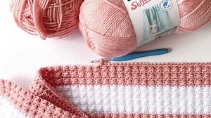 Do you know the berry stitch? 🍓 Hannah of Daisy Farm Crafts is showing us how to work this fruity stitch in Bernat Softee Baby yarn. Watch her demonstrate the Berry Stitch followed by a single crochet stitch to make an adorable nursery blanket. Get the crochet pattern: https://bit.ly/3BCRgae Shop the yarn: https://bit.ly/3zhjmWm | Yarnspirations