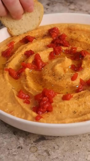 Dollar Tree Roasted Red Pepper Hummus You will need: 2 cans of chick peas $2.50 1 jar of roasted red pepper strips $1.25 Lemon Juice $1.25 Citrus Garlic Seasoning (or other seasoning of choice) $1.25 Olive Oil Chips / Crackers for dipping I’m going to give you the recipe for the entire batch but just know that I had to blend mine in two batches because of my blender size. Start by draining your 2 cans of chick peas but save the liquidand also peel them for a super smooth hummus. I rub them again