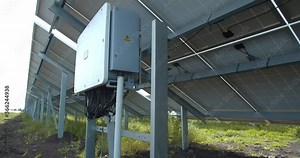 Row of the solar panels, view from the back with a control box, 4k