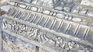 Close-up of ancient Roman relief carvings in Carthage, Tunisia, showing historical detail