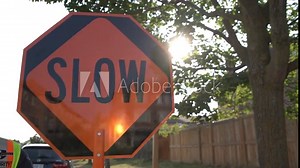 Traffic control with stop slow sign according to construction plan