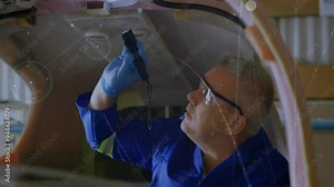 Engineer working on aircraft cockpit with technical schematics animation overlaid