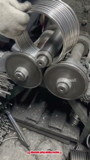 Adjustable spring winding machine