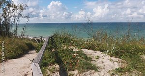 Curonian spit, beautiful vibrant view of Kurshskaya Kosa National Park, Curonian Lagoon and the Baltic Sea, Kaliningrad Oblast, Russia and Klaipeda County, Lithuania, summer day, with a female tourist