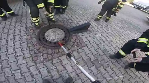 German Firefighters Work To Free Rotund Rat Stuck In Manhole Cover