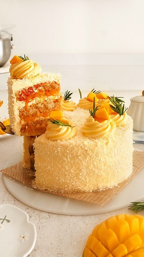 MANGO COCONUT CAKE🥭 COMMENT ‘ CAKE’ and I’ll DM you the recipe link!! Follow @thelittleblogofvegan for the best vegan recipes! Unbelievably fresh & fruity - Layers of mango & vanilla swirl sponges, a creamy mango frosting, with mango puree & coconut, topped with more mango, coconut & some rosemary!🥭🌴 This cake is DELICIOUS, and surprisingly easy to make! NO-EGG, NO-DAIRY.. not that anyone will know! Enjoy friends🫶🏻 ———-> Get the recipe: thelittleblogofvegan.com Type ‘Vegan Mango Coconut Cak