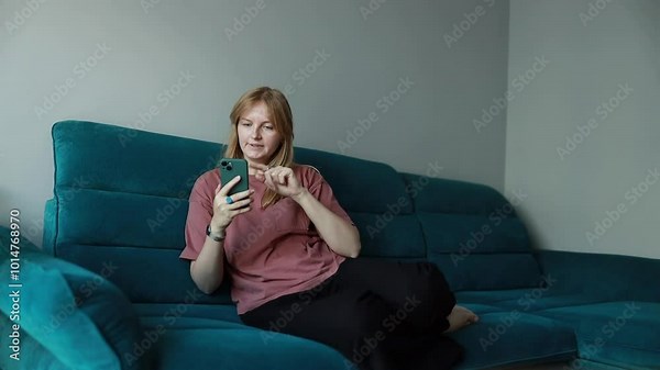 Frustrated woman scrolling phone. Failed transaction concept. Unhappy phone holding. Sad unhappy woman surfing phone. Technical issues concept. Phone malfunction. Problem with connection
