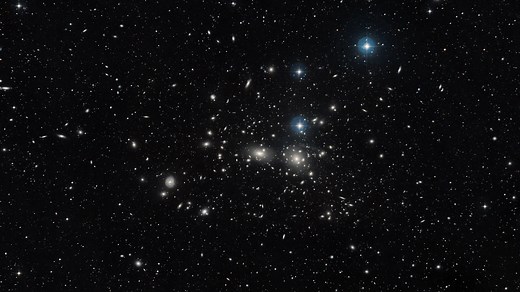 Zooming into The Coma Cluster | NOIRLab-DOE Dark Energy Camera FriendsofNASA.org: The Dark Energy Camera captured an image of the dazzling Coma Cluster, named after the hair of Queen Berenice II of Egypt. Not only significant in Greek mythology, this collection of galaxies was also fundamental to the discovery of the existence of dark matter. The theory emerged in 1937 when Swiss astronomer Fritz Zwicky noticed that the Coma Cluster galaxies behaved as if they were under the influence of vast am