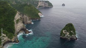 Steep limestone cliffs at craggy coast meet the Indian Ocean, Paluang Cliff on Nusa Penida Island, Indonesia