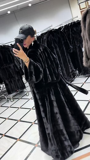 Stylish Black Fur Coat Try-On in Modern Clothing Store