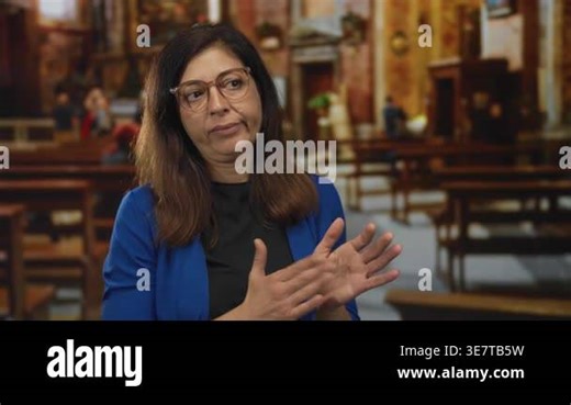Woman clapping hands in church during a religious service with rows of benches and ornate decorations; devotion Stock Video Footage - Alamy