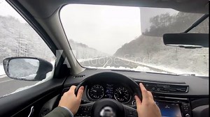first person point of view man hands on steering wheel driving car by highway