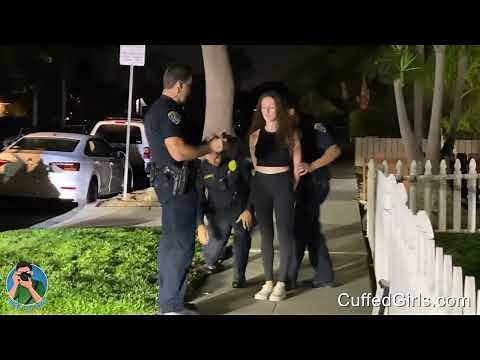 Beautiful girl handcuffed behind her back by police after car damage