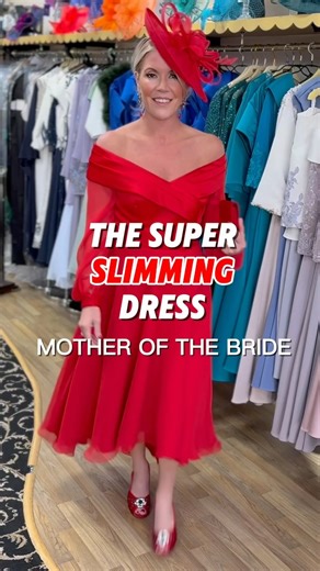 Step into the spotlight in this super-slimming dress designed to sculpt, lift, and flatter from every angle. Featuring a youthful Bardot neckline and playful puff sleeves, it brings romantic energy with a modern twist. The high-low hemline adds movement and drama-perfect for dancing the night away. Made for mothers of the bride who want to feel confident, elegant, and anything but ordinary. Available in 50 colours sizes 8-32 #motherofthebridedress #motherofthegroom #mumofthebride #motherofthebri