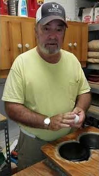 Waxing shuffleboard discs.