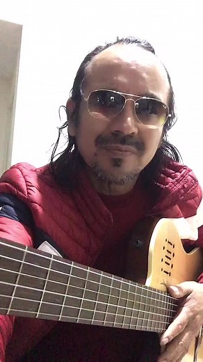 Acoustic Guitar Performance by Long-Haired Musician