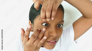 Young woman, close-up, inserting a contact lens in her eye
