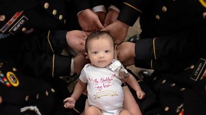 Troops have photo shoot with baby of fallen soldier