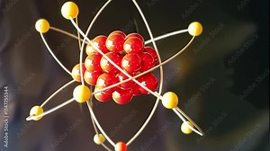 Atomic structure: video electrons orbiting nucleus, their energy levels and motion within the electron shell, dynamic interplay of protons, neutrons, and electrons.