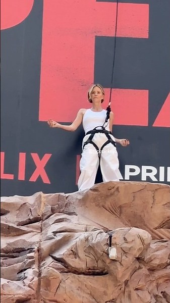 At the Apex of NYC 👑 Charlize Theron climbs high above Times Square