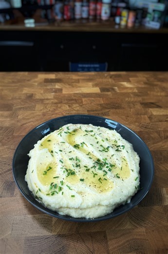 These Mashed Potatoes are perfect for your Holiday meal! CJ is showing you how to make the most flavorful mashed potatoes! What you’ll need: -4lbs Yukon Gold potatoes (peeled) -2 cups heavy cream. -4oz salted butter. -Couple sprigs of thyme. -Couple sprigs of rosemary. -4 cloves of garlic (smashed) -Salt and pepper to taste. How to make it: Quarter the potatoes. Please the potatoes in salted water and bring to a boil. Boil the potatoes until fork tender. In a pan, add the cream, herbs, garlic an