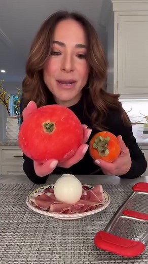 FROZEN GRATED PERSIMMON & BURRATA! I just makes sense!! Pick up a hachiya persimmon at your local grocery store. Wait until the hachiya persimmon is ripe and the flesh is super soft, then freeze it for at least 12 hours. Plate prosciutto, burrata as shown, then use a cheese grater to grate the persimmon over the burrata. Drizzle extra virgin olive oil and aged balsamic over the grated persimmon. Sprinkle with flakey sea salt and spread on toast! #foodtrend #burratta #persimmon #frozentomatoes #v