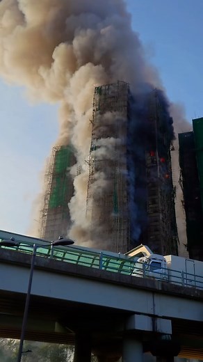Firefighters are scrambling to put out a fire that's spreading quickly to other residential buildings in the Tai Po district in Hong Kong | The Mirror