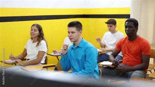 Lesson in the classroom of the driving school - students at their desks and take a theoretical course of work in a taxi