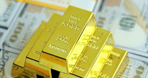 Pyramid from gold bars with bank stamps on stacks of dollar bills in light studio. Concept of money investment and accumulation in bank