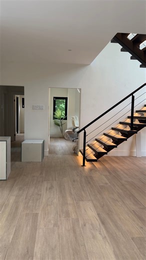 CADCO DESIGN BUILD on Instagram: "✨ Tobago Plantations – Progress Update ✨ 5 Bedrooms | 5.5 Bathrooms Highlights: • Open-concept living with large tempered glass doors & windows • Sleek white kitchen with black accents + pantry • White wet bar with seamless countertop & backsplash • Mono-stringer staircase with LED-lit open treads & black railing • Office & gym spaces • Guest bedroom with ensuite & pool access • Backyard oasis: Swimming pool, Jacuzzi & outdoor grill • Built-in closets & bathroom