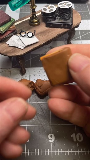 A tiny book that should never be read aloud. A hand carved cover, a reel to reel waiting to spin, and a table coming together. Props first. Consequences later. 🖤📖🕯️ #atroposmediaworks #tinyhorror #miniatureart #handmadehorror #evildeadvibes | Atropos Mediaworks