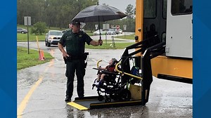 Sweet photo shows school resource deputy shield student from the rain