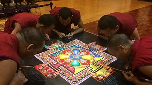 Tibetan monks create sand mandala in the mountains