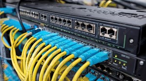 Engineer installing an unmanaged network switch in a small office setup focusing on simple plugandplay connectivity without advanced configuration requirements.