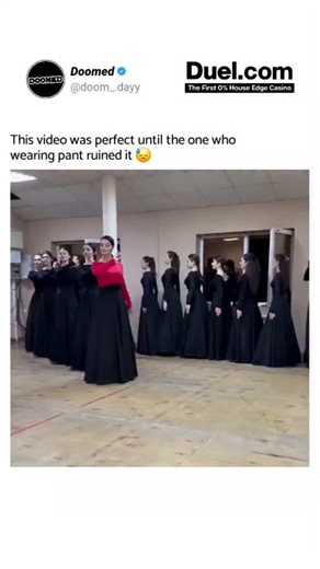 𝗗𝗢𝗢𝗠𝗘𝗗 ⚠ on Instagram: "The reel captures a perfectly synchronized group of women dressed in matching black skirts and red tops, their arm movements flowing together like one rhythm—until one tiny detail crashes the harmony and steals the whole spotlight: the lone participant who showed up in pants. As everyone else sways in coordinated skirts, her outfit breaks the entire visual symmetry, turning what was meant to be a graceful cultural dance into an unintentionally hilarious moment of mi