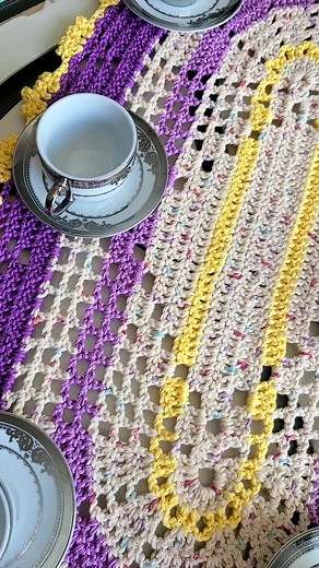 Oval Lavender and Gold doily #CROCHET 💜💛🤍 Add warmth and charm to your home with this beautiful, handmade crocheted table runner. The vibrant purple and yellow colors will brighten up any room, while the intricate design adds a touch of elegance. Measuring approximately 24 inches in length and 12 inches in width, this oval-shaped piece is the perfect size for a dining or coffee table. Made from high-quality materials, this table runner is both durable and easy to care for. Imagine gathering a