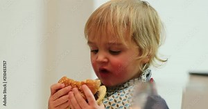 Baby toddler eating burger for dinner. Young boy eating hamburger for the first time for supper10