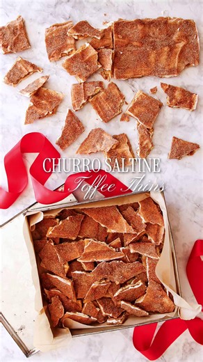 These Churro Saltine Toffee Thins start with a layer of salty saltine crackers, coated in a buttery brown sugar caramel, then finished with melty white chocolate and a sprinkle of cinnamon sugar for that classic churro flavor. Crispy, chewy, sweet, and just a little bit salty; they're dangerously snackable and perfect for holiday gifting or to present on party trays. Get the recipe here: https://ow.ly/Mb4q50XzMkk | Chef Darins Kitchen Table - Hands-on Cooking Classes & Kitchen Store