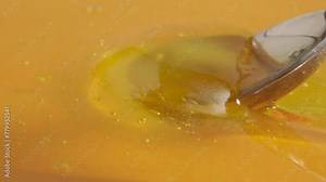 Healthy organic honey. Sweet fresh golden honey on the yellow background with honey spoon scooping thick liquid, close up.