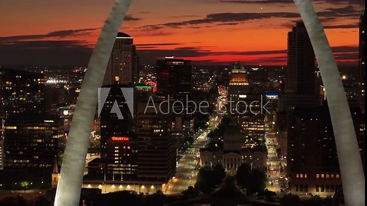 Breathtaking aerial view of St. Louis skyline at sunset, featuring the iconic gateway arch and illuminated cityscape in this major travel destination